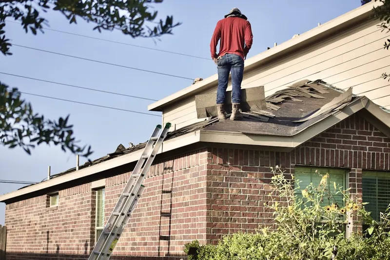 Professional roofer working on a residential roof in Homestead Park